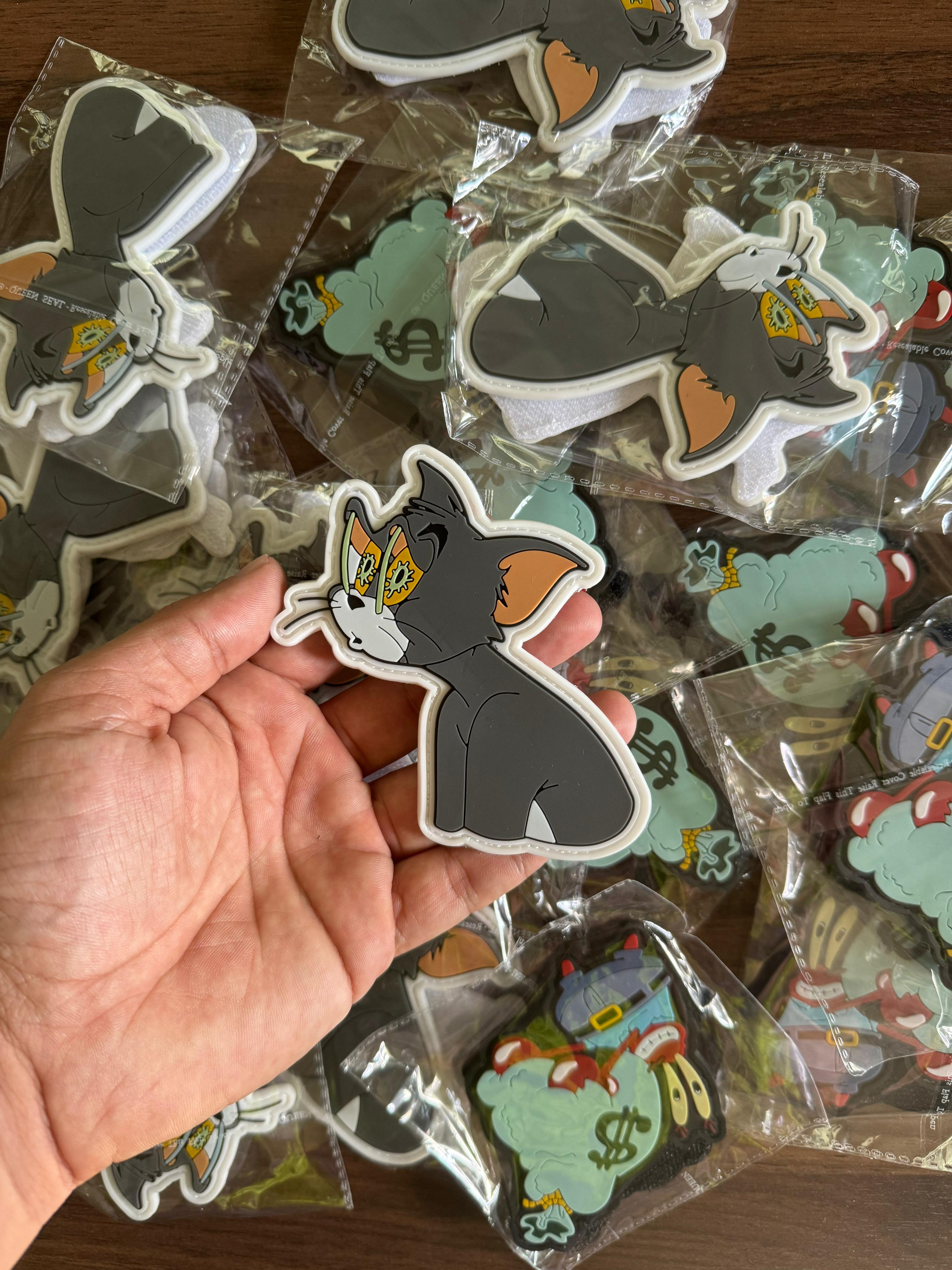 Custom PVC patch featuring Tom cartoon design with expressive details, high-quality rubber patch for bags, jackets, and collections.