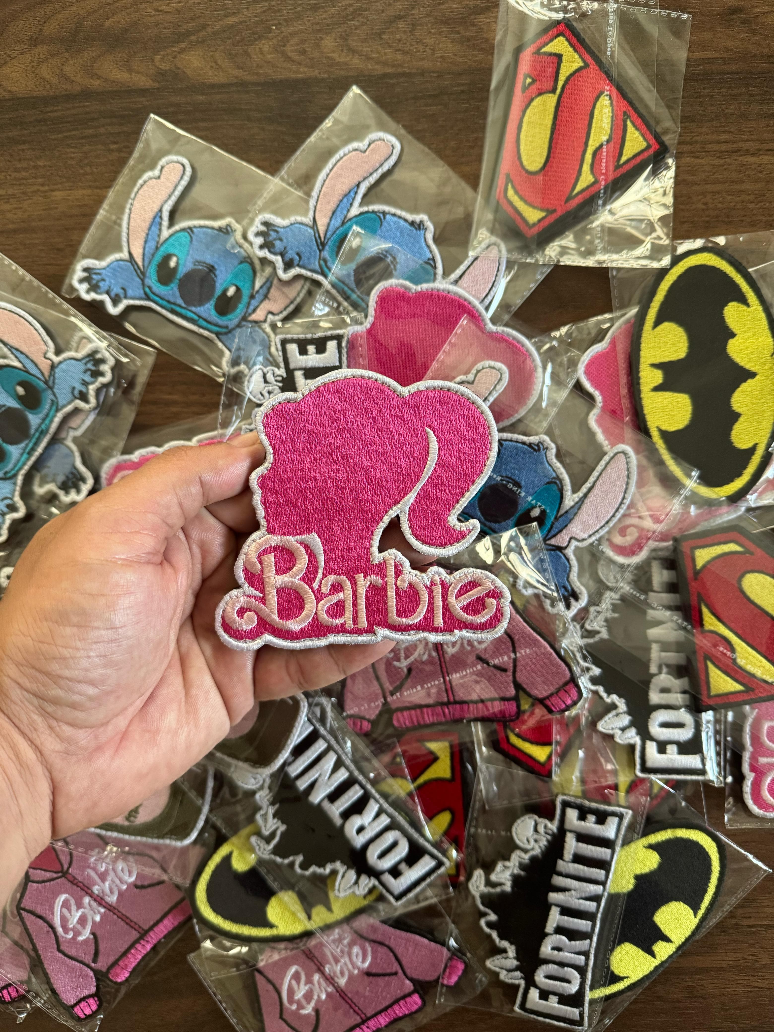 Pink Barbie silhouette sew-on embroidered patch with white border, perfect for clothes and bags