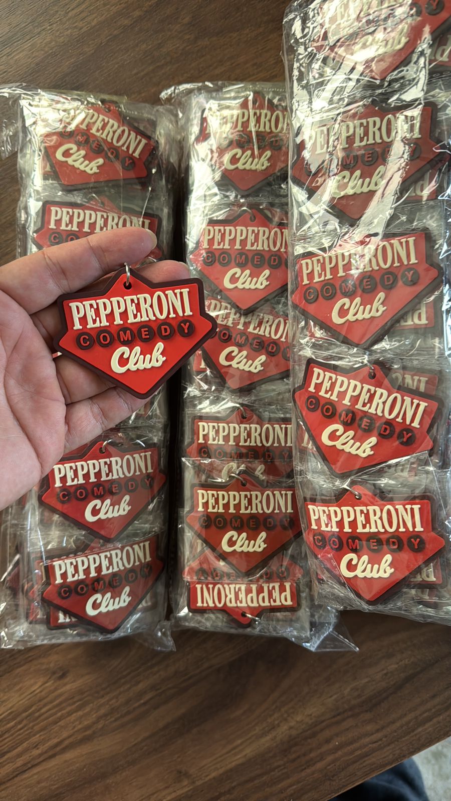 Red and white custom PVC patch designed for Pepperoni Comedy Club, showcasing bold rubber material and detailed branding.
