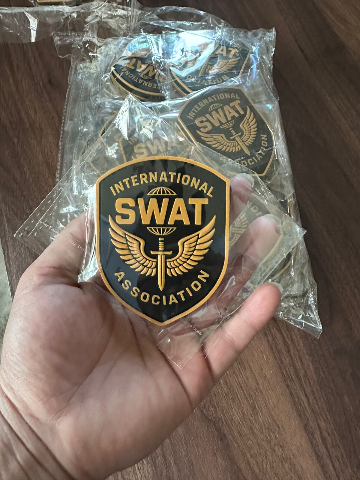 High-quality round custom PVC patch with embossed SWAT Association logo in yellow and black rubber, ideal for tactical use.