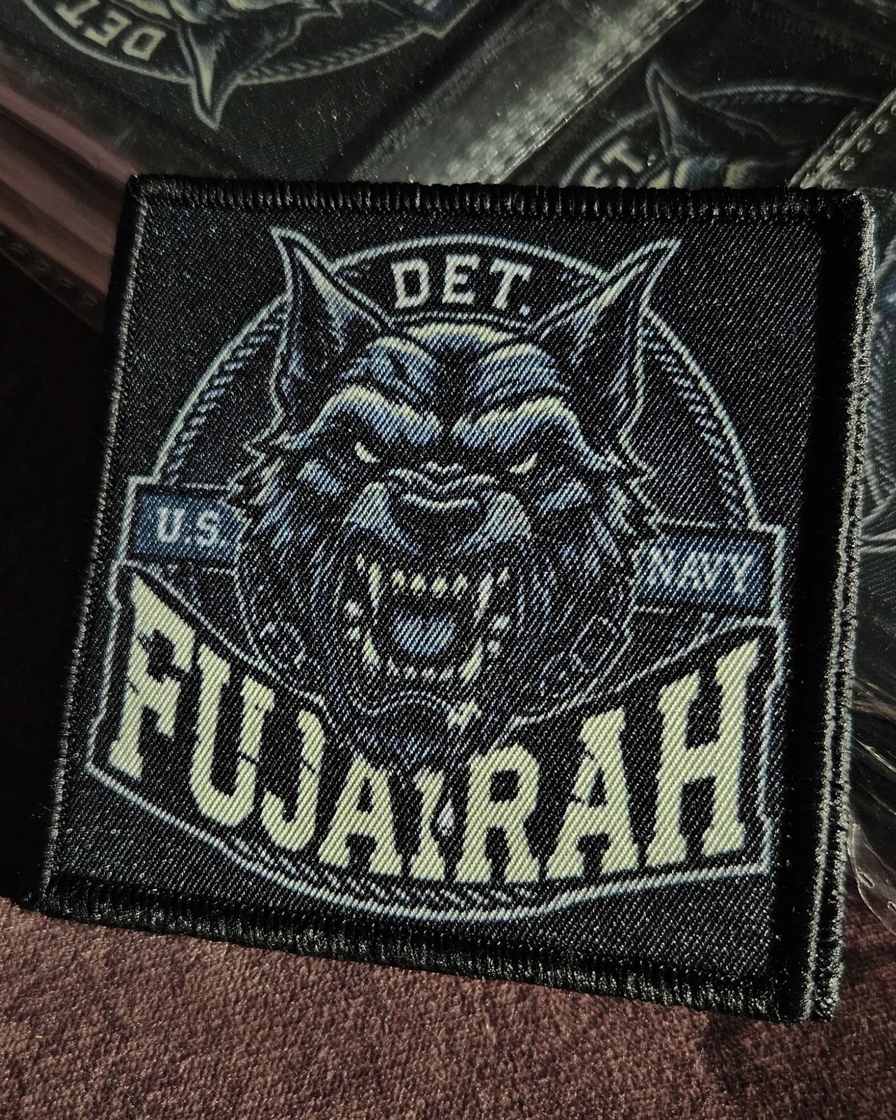 Detailed woven patch featuring Fujairah text and fierce wolf head artwork — a premium woven label for uniforms and custom woven patches in bulk orders.