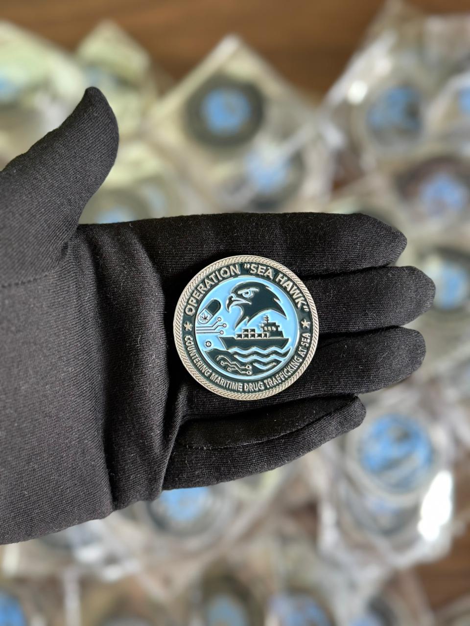 Operation Sea Hawk challenge coin in silver finish with ship and wave artwork. Custom-made military coin representing maritime operations and unit pride.